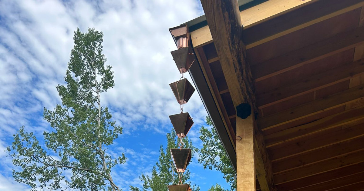 Decorative rain chain on porch guiding water from gutter