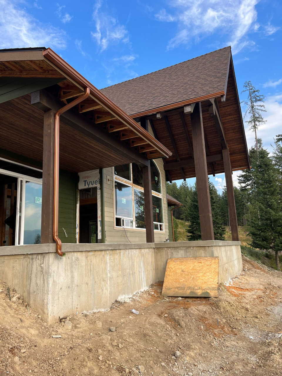 House with porch and fresh gutter installation