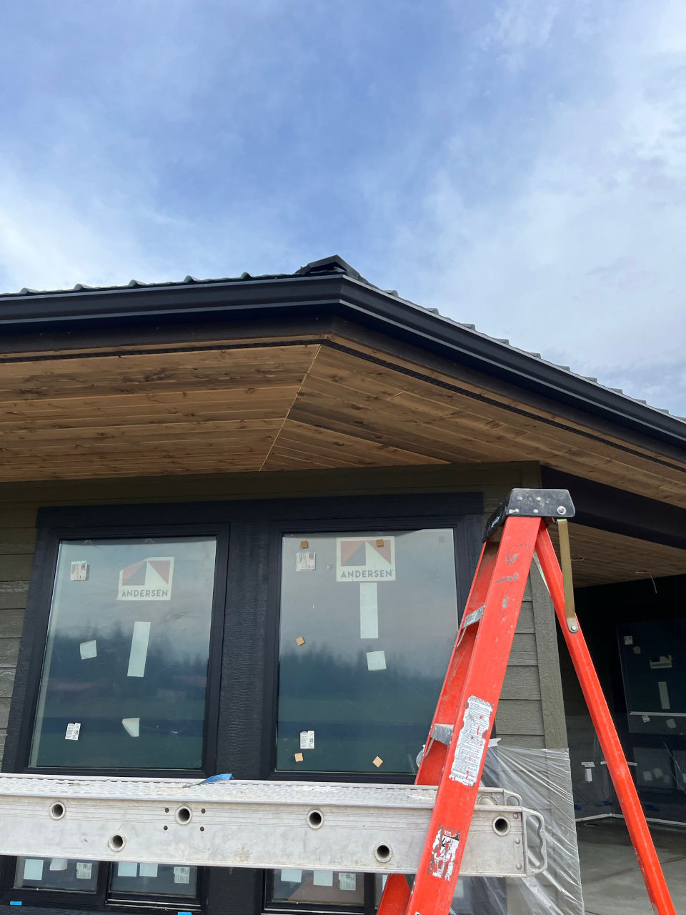 Gutter technician on ladder during gutter repair or replacement