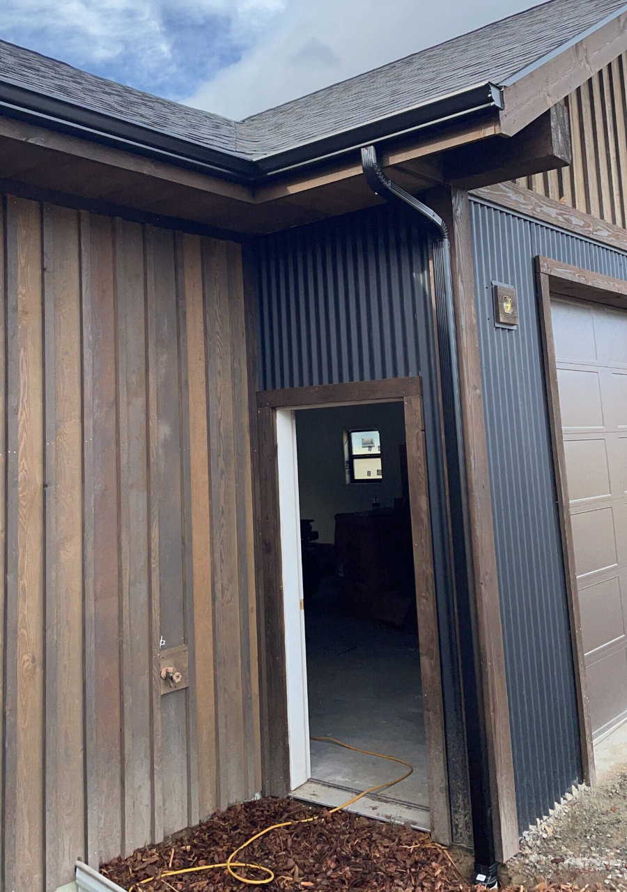 Dark metal building with gutter system